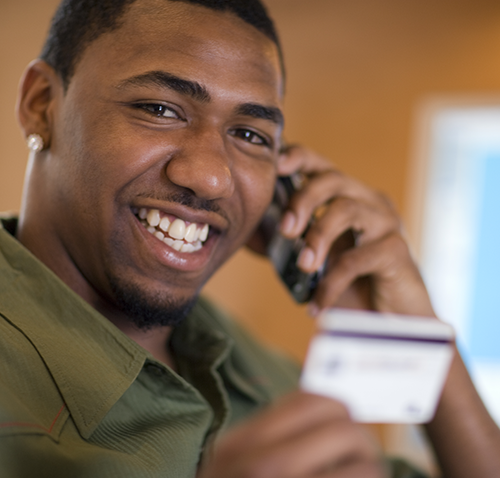 Man on the phone holding credit card